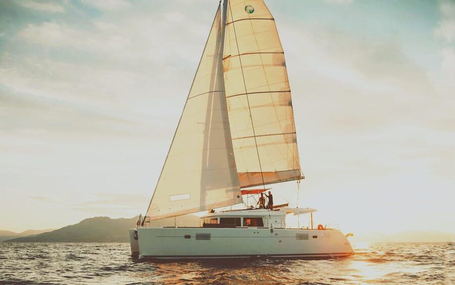 Rethymno: Sunset Catamaran Cruise - Sushi & Open Bar - Cruising the coast on a modern catamaran deck